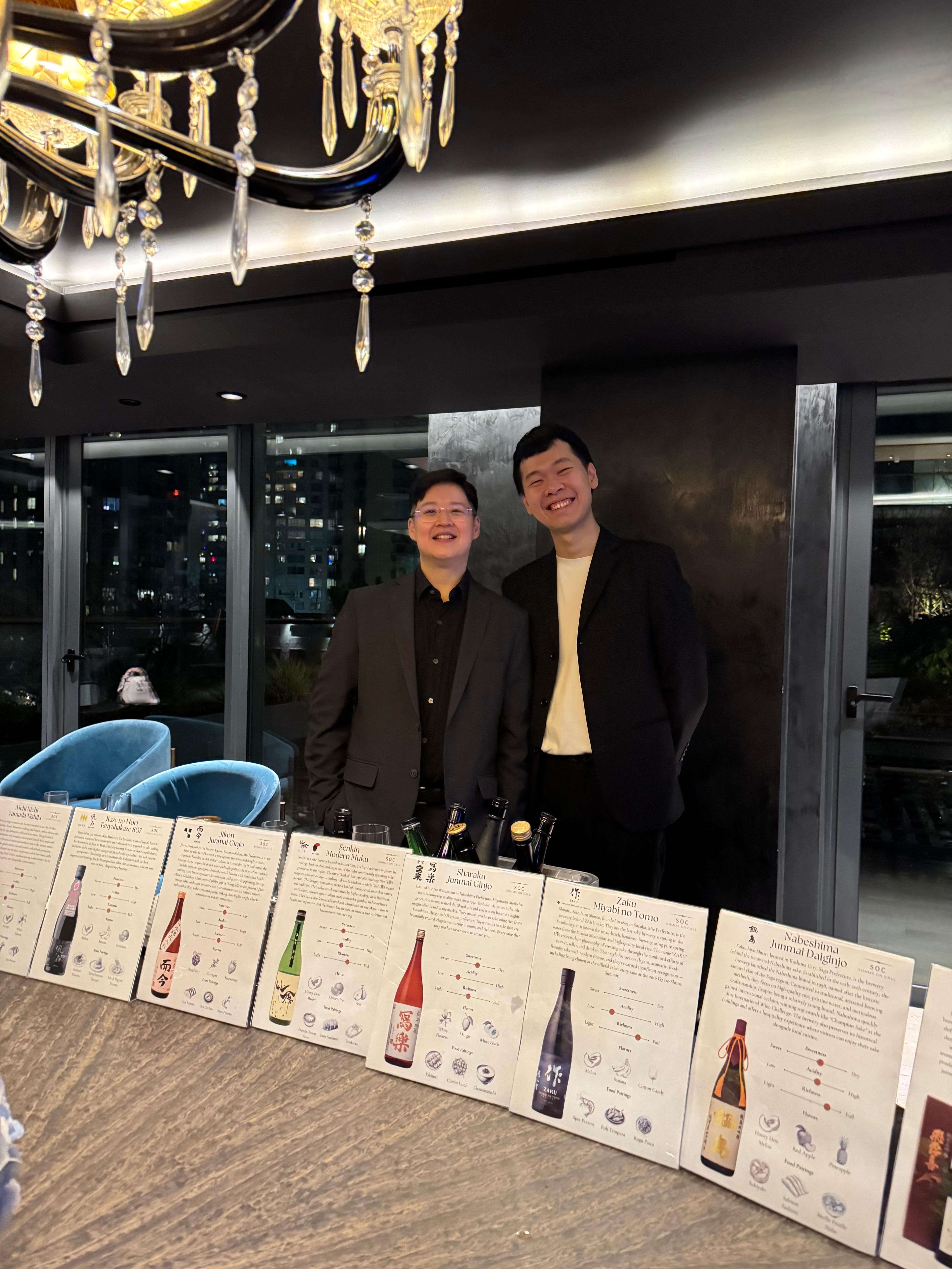 Spencer and Andre behind a sake tasting flight