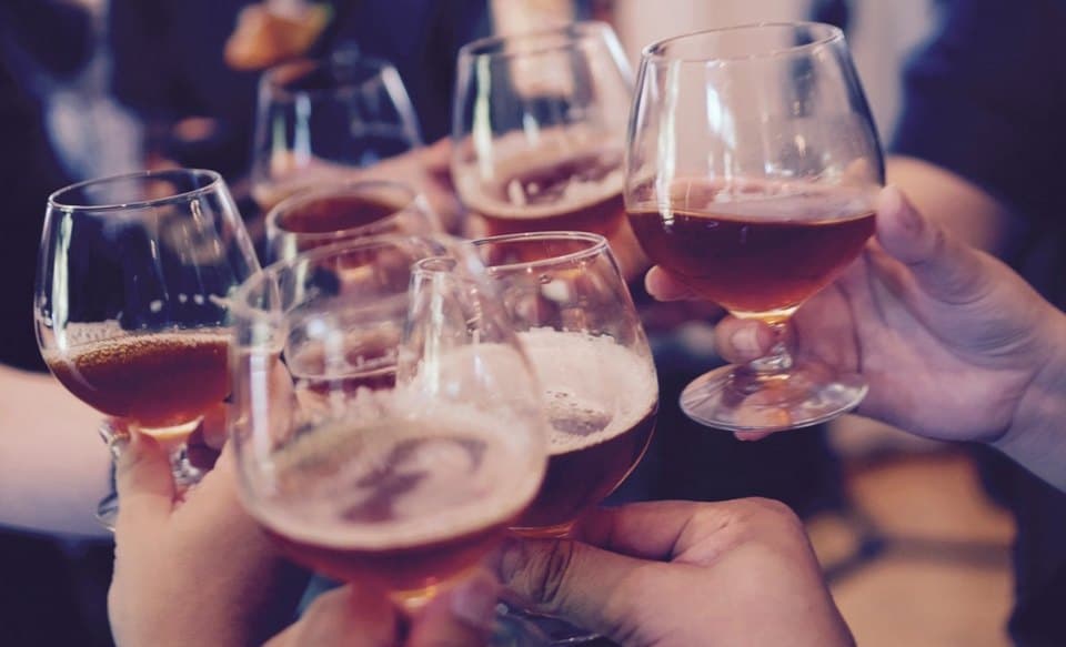 Friends raising glasses together around a table